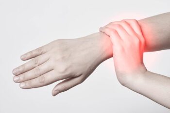 Woman gripping wrist in pain.