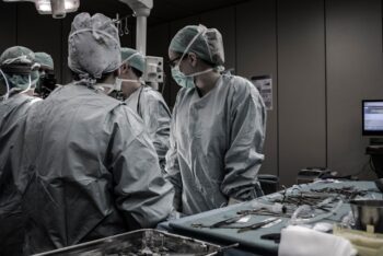 doctors performing hand surgery