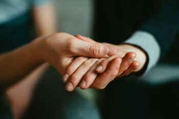 Two people holding each other's hands