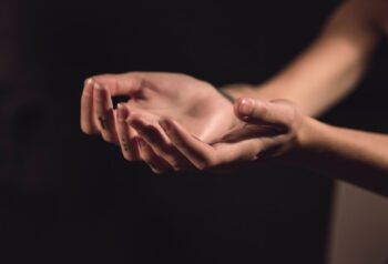 Outstretched hands with palms facing upwards.