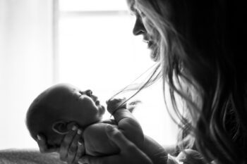 A woman holding her newborn baby.
